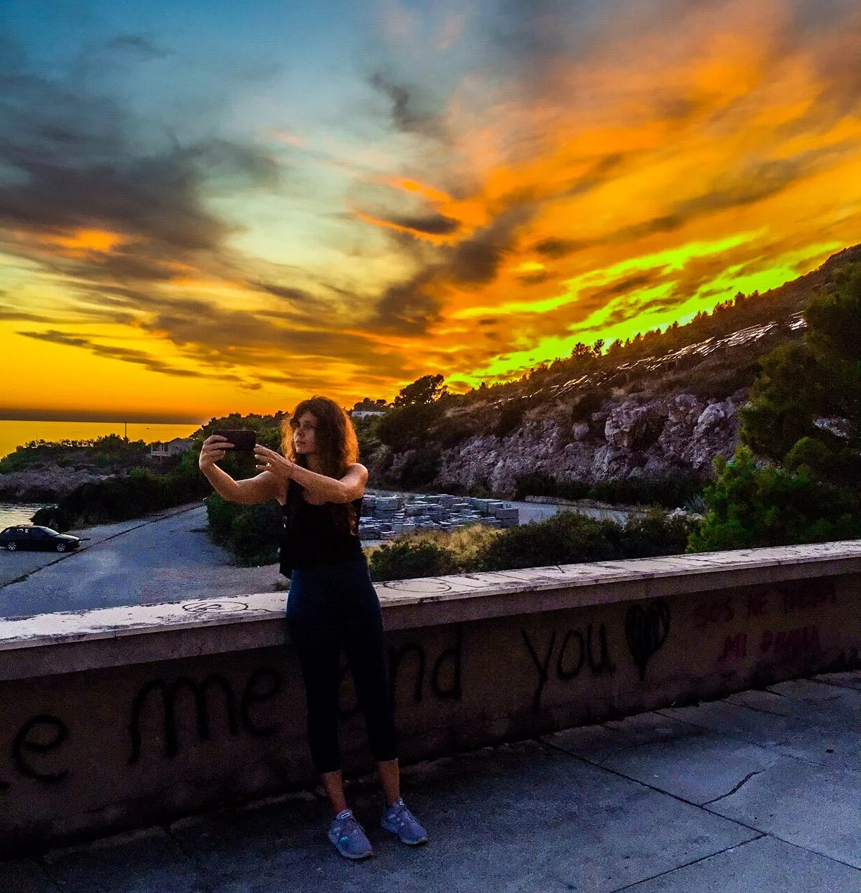 Rozzebud beneath a vibrant sunset during her travels